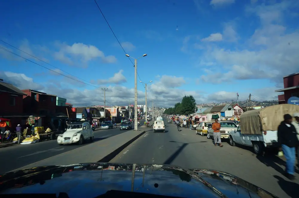 Meandering through Tana's traffic. The little 60s Volkswagen beetle looking car is the main taxi style of the capital. 