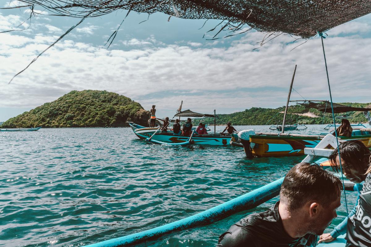 surf in lombok indonesia, catching a wave